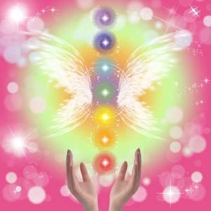 Photo of hands holding the 7 chakras with wings