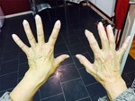 Photo of a pair of hands showing Quantum Touch energy healing on the left hand